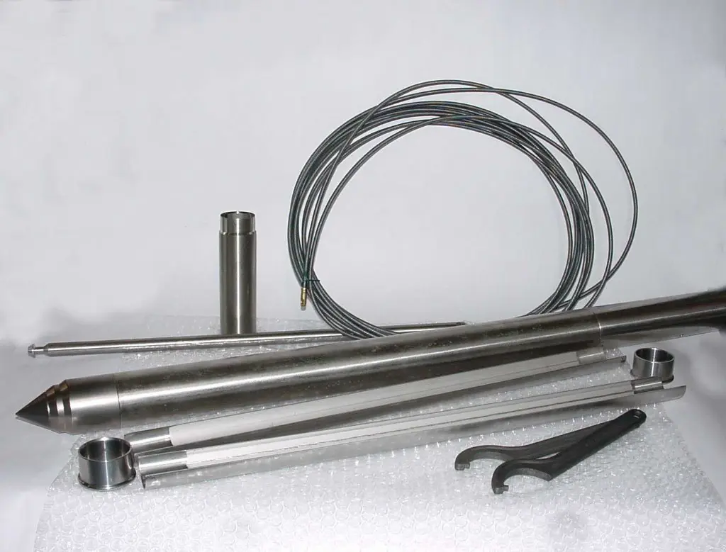 A group of metal pipes and wires on top of a table.
